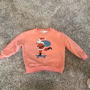 Minimalist Folk Co: Santa Claus Skateboarding Peach colored Sweatshirt